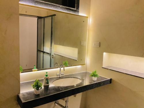 a bathroom with a sink and a large mirror at Origin Suites Luxury Boutique Hotel Pushkar in Pushkar
