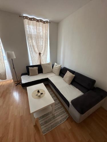 a living room with a couch and a table at Cozy Ground Floor Apartment Near U6 Easy Access to Center in Vienna