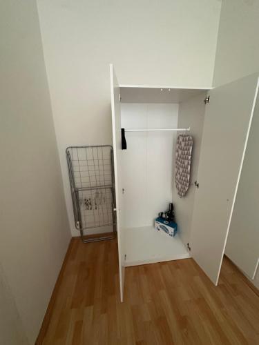 a room with a white door and a wooden floor at Cozy Ground Floor Apartment Near U6 Easy Access to Center in Vienna
