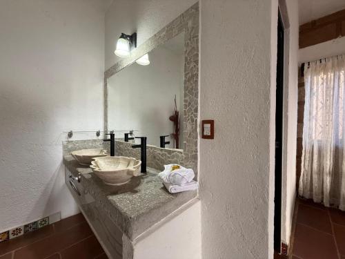 a bathroom with a sink and a mirror at Wellness Casa Doña Juana in Tepoztlán