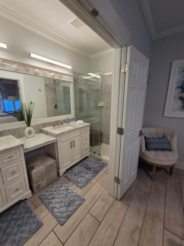 a bathroom with a shower and a sink and a mirror at Pelican's Perch in Santa Rosa Beach