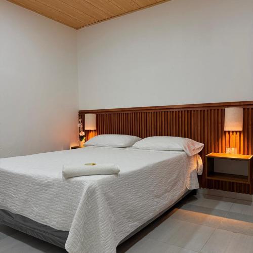 a bedroom with a large bed with a white blanket at La Casona in Arauca