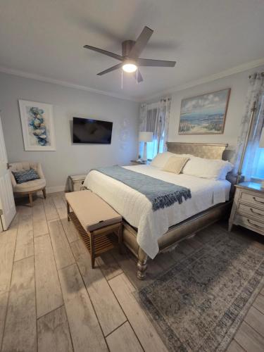 a bedroom with a large bed with a ceiling fan at Pelican's Perch in Santa Rosa Beach