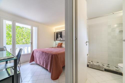 a bathroom with a bed and a shower in a room at Muta House in Sorrento