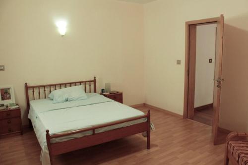a bedroom with a bed and a wooden floor at Flat Mimmo in Praia
