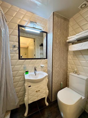 a bathroom with a sink and a toilet and a mirror at Silver 34 Boutique in Tbilisi City