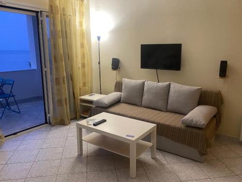 a living room with a couch and a table at michelangela in Ireon