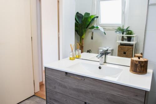 a bathroom with a sink and a mirror at Chitaka's Organic Farmhouse in Ribatejo in Santo Estêvão