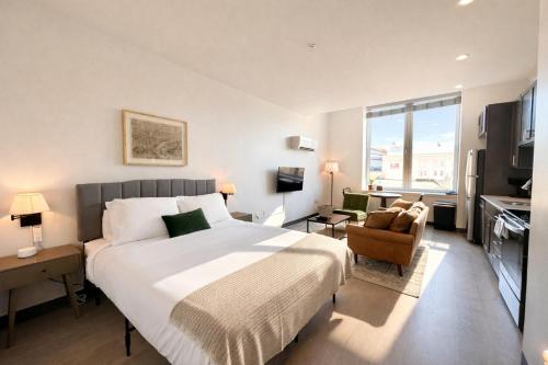 a bedroom with a large bed and a television at Deer District Studio Apt - One Block from Fiserv and Baird in Milwaukee