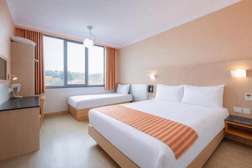 a hotel room with a large bed and a window at Eurotraveller Hotel - Premier - Harrow in Harrow