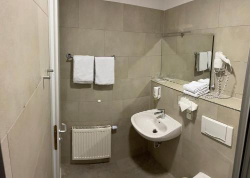 a bathroom with a sink and a mirror at Hotel Amadeus Dresden Neustadt in Dresden