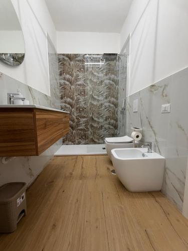 a bathroom with a sink and a toilet and a shower at Casa Arco Varano in Crotone