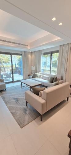 a large living room with couches and a table at Solo Realty Apartments at Address Residence Fujairah in Sharm