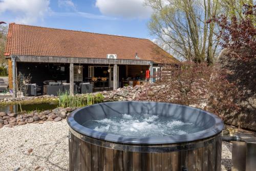 a hot tub in the yard of a house at Studio with Pool Table and Optional Sauna & Hot Tub in Zwaanshoek