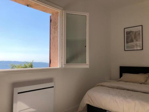a bedroom with a window and a bed in it at French Riviera near Nice Monaco, Apartments in Villa, Sea Montain View in Carros