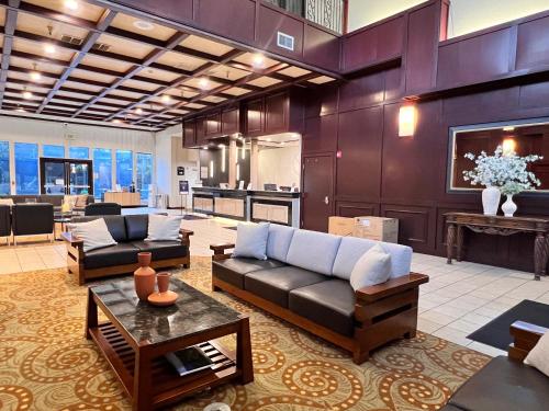 a large living room with couches and a kitchen at Ramada by Wyndham Tukwila Southcenter in Tukwila