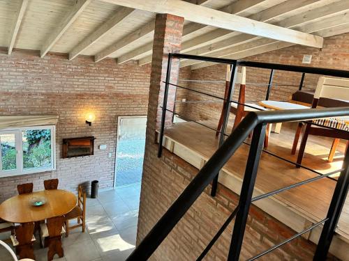 a staircase in a brick building with a table and a dining room at Duplex Las Margaritas Bosque Peralta Ramos in Mar del Plata