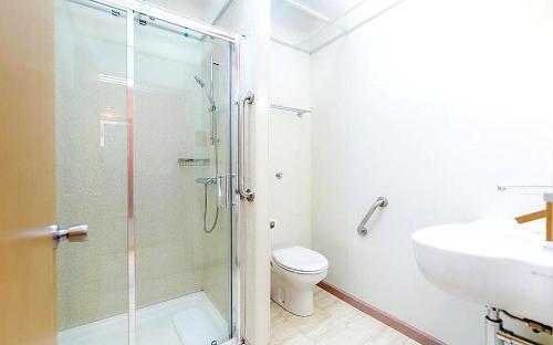 a bathroom with a shower and a toilet and a sink at Eurotraveller Hotel - Premier - Harrow in Harrow
