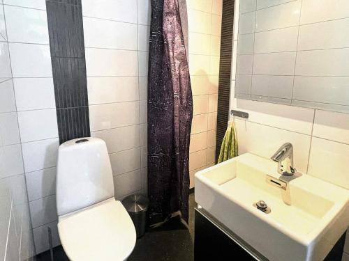 a bathroom with a sink and a toilet and a mirror at 4 star holiday home in SÖLVESBORG in Sölvesborg