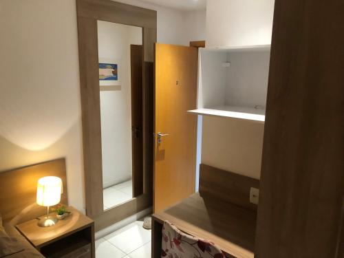 a room with a room with a door and a lamp at Aparthotel diamond flat in Nova Iguaçu