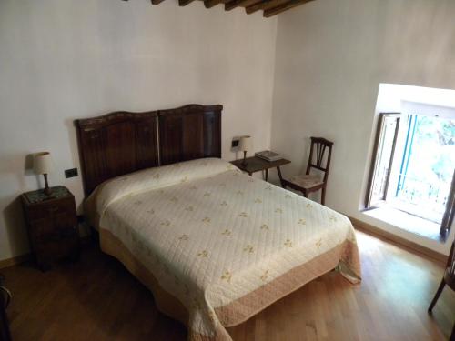 a bedroom with a bed and two chairs and a window at Casa Tucci in Reggello