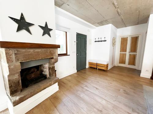 a living room with a fireplace and two stars on the wall at La casa de Cabuérniga in Cabuerniga