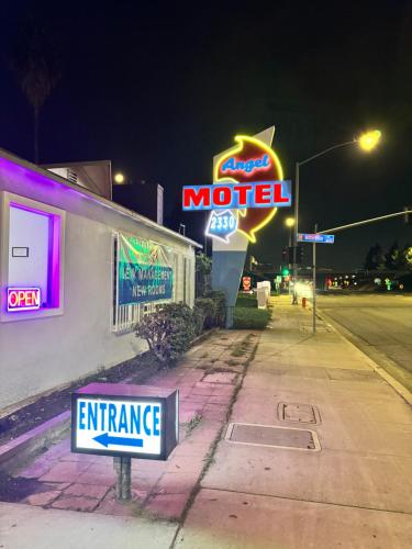 a motel sign on the side of a building at night at Angel's Motel near Anaheim in Orange