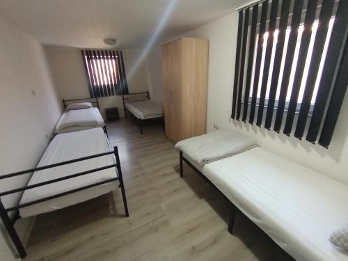 a room with two bunk beds and a window at Apartman TATTOO R LUX in Negotin