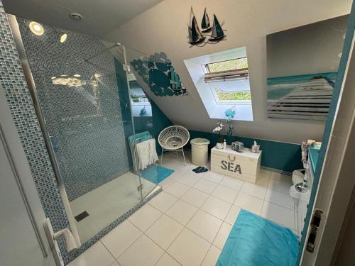 a bathroom with a shower and a sink and a shower at Au Bois Dormant in Monterblanc