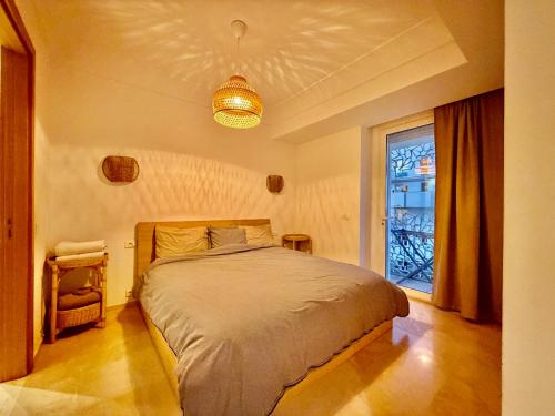 a bedroom with a large bed and a window at Modern and cozy CFC apartment in Casablanca
