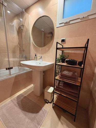 a bathroom with a sink and a mirror and a tub at Casa Sol Serena - Pool, Beach & Golf in Los Alcázares