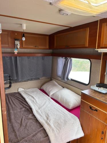 a small bed in the back of an rv at A little paradise 2 in Radanovići