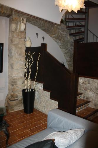 a living room with a staircase and a stair case at Cal Arxè in Besalú