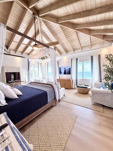 a bedroom with a bed with a blue comforter at Villa Serena Water Island in Water Island
