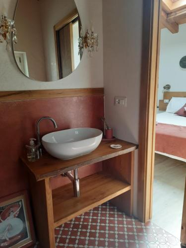 a bathroom with a sink and a mirror at CamElia in Garlenda