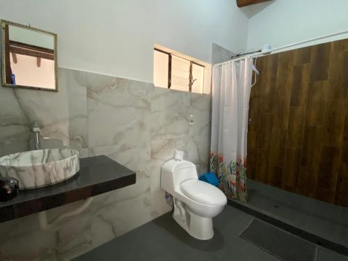 a bathroom with a toilet and a shower and a sink at Raíz Azul in Pisac