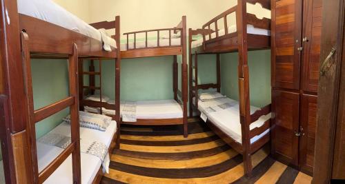 a room with three bunk beds in a room at Sobrado Antonieta in Belém
