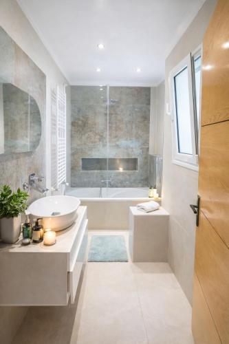 a bathroom with a white tub and a sink and a tubermott at Dar Al Yaqout in Le Kram