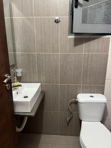 a bathroom with a toilet and a sink at Meta apartment in Ksamil