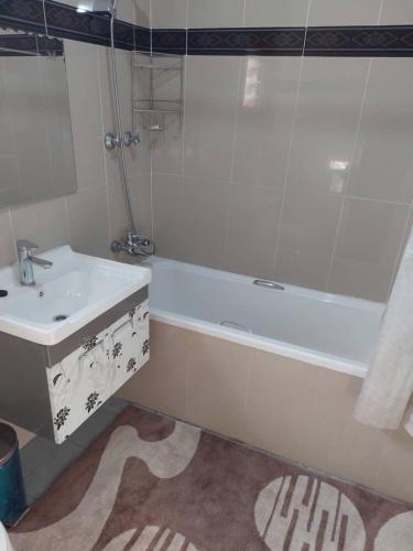 a bathroom with a tub and a sink and a bath tub at Samfya waterfront lodge 