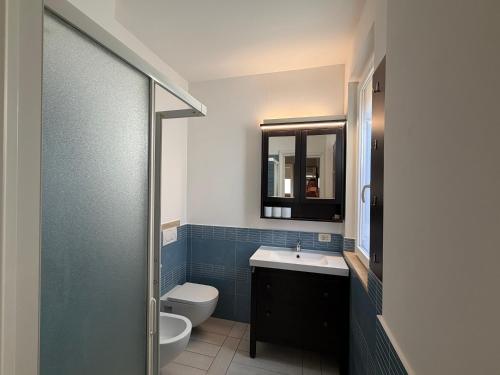 a bathroom with a toilet and a sink and a shower at Al Piano 2 in Ancona