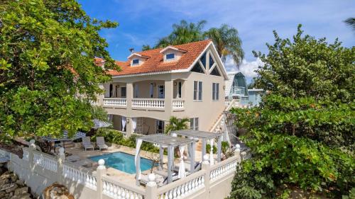 an exterior view of a house with a swimming pool at Tres Sirenas Beach Inn in Rincon