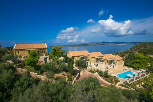 an aerial view of a house on a hill with a lake at Ionian Vista Villas in Argostoli