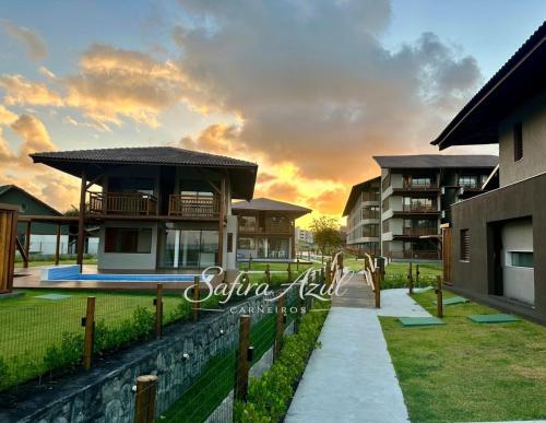 a sunset view of a villa in a resort at Safira Azul Luxury Flat Carneiros in Tamandaré
