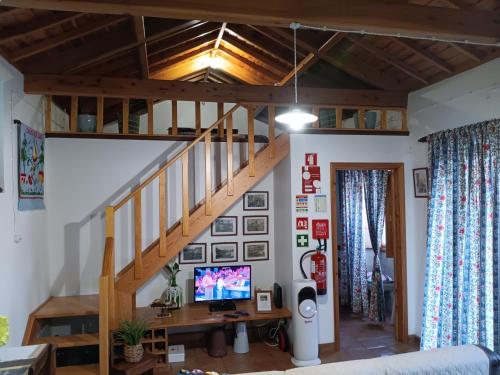 a living room with a staircase in a house at Casa da Fonte in Angra do Heroísmo