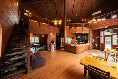 a large room with a staircase and a dining room at ホテル 木綿恋記 -Hotel Yufugoiki- in Yufu