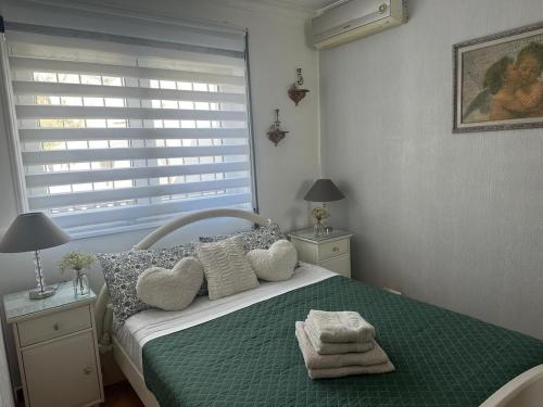 a bedroom with a bed with towels on it at Swallows Nest in Quarteira