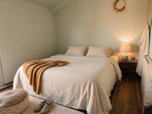 a bedroom with a bed with a blanket on it at Maison Douce in Châteaurenard