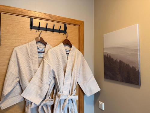a robe hanging on a door in a room at Studio with Private Spa Garden in Njarðvík