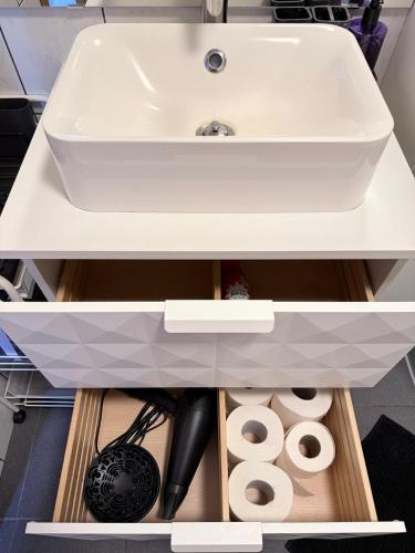a white bathroom sink sitting on top of a cabinet at Studio with Private Spa Garden in Njarðvík